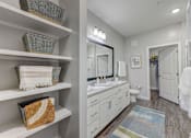 Thumbnail 18 of 39 - a bathroom with a sink and a mirror at Century Mundy Mill Apartments, Georgia 30566