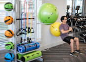 Thumbnail 15 of 39 - a man exercising in the gym at a health club at Century Mundy Mill Apartments, Oakwood 30566