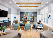 Thumbnail 29 of 39 - a living room filled with furniture and a kitchen at Century Mundy Mill Apartments, Oakwood, GA 30566