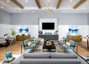 Thumbnail 25 of 39 - a living room with a couch and a table at Century Mundy Mill Apartments, Oakwood, GA 30566