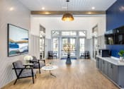 Thumbnail 30 of 39 - a living room with blue and white walls and a wood floor at Century Mundy Mill Apartments, Georgia