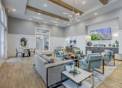 Thumbnail 35 of 39 - a living room with couches and chairs and a table at Century Mundy Mill Apartments, Oakwood, GA 30566