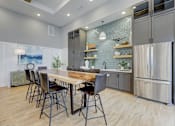 Thumbnail 36 of 39 - a kitchen with stainless steel appliances and a wooden table with chairs at Century Mundy Mill Apartments, Georgia