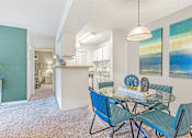 Thumbnail 4 of 18 - A dining room with a glass table and blue chairs. at Grove at St. Andrews, Columbia