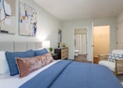 Thumbnail 4 of 31 - A bedroom with a large bed and a chair.