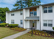 Thumbnail 34 of 34 - a white building with a gray awning and a green lawn at Summit Augusta, Augusta, GA 30909