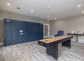 Thumbnail 27 of 31 - A room with a long table and a row of lockers.