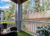 Thumbnail 23 of 31 - A chair with a pillow is on a porch.