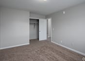 Thumbnail 26 of 27 - a bedroom with gray walls and carpet