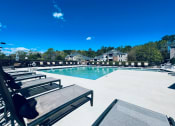 Thumbnail 3 of 37 - sparkling swimming pool with lounge chairs at Palmetto Place, South Carolina, 29708