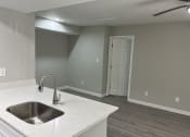 Thumbnail 28 of 33 - a kitchen with a sink and a ceiling fan at The Hub at 934 Apartments, Georgia, 30349