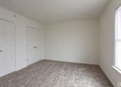 Thumbnail 24 of 30 - a bedroom with a carpeted floor and a white door