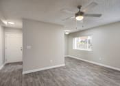 Thumbnail 11 of 34 - A room with a ceiling fan and a window with blinds.