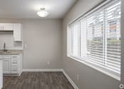 Thumbnail 14 of 34 - A kitchen with white cabinets and a granite countertop.