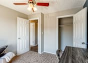Thumbnail 19 of 30 - A room with a ceiling fan and a dining table.