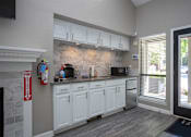 Thumbnail 15 of 27 - a kitchen with white cabinets and a sink and a window