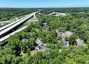 Thumbnail 11 of 27 - an aerial view of a neighborhood next to a highway