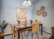 Thumbnail 4 of 31 - A dining room with a wooden table and chairs.
