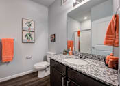 Thumbnail 5 of 31 - A bathroom with a toilet, sink, and towels.