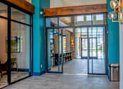 Thumbnail 25 of 36 - A blue wall with a wooden beam above a glass door.