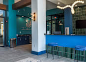 Thumbnail 27 of 36 - A blue bar with a white column and a TV mounted on the wall.