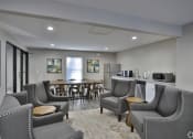 Thumbnail 6 of 19 - a community room with chairs and a bar and a kitchen