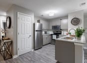 Thumbnail 7 of 17 - our spacious kitchen is equipped with stainless steel appliances and a granite counter top