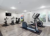 Thumbnail 4 of 17 - a gym with treadmills and other exercise equipment and a tv