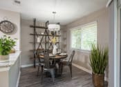 Thumbnail 8 of 17 - a dining room with a table and chairs and a clock on the wall