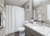 Thumbnail 11 of 17 - a bathroom with a sink and a toilet and a shower