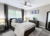 Thumbnail 10 of 17 - a bedroom with a bed and a ceiling fan