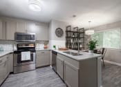Thumbnail 1 of 17 - an open kitchen with stainless steel appliances and granite counter tops
