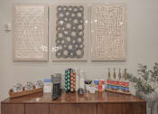 Thumbnail 44 of 49 - three pieces of artwork hanging on the wall above a counter with coffee and other items at Century HomePlace, Prattville, 36066