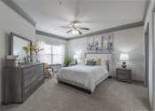 Thumbnail 45 of 49 - a bedroom with a bed and a ceiling fan at Century HomePlace, Prattville Alabama