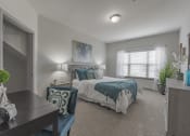 Thumbnail 43 of 49 - a bedroom with a bed and a desk and a window at Century HomePlace, Prattville, AL