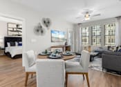 Thumbnail 16 of 29 - A modern living room with a dining table set for four.at Century Grove Park, Knightdale, 27545