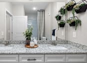 Thumbnail 25 of 29 - A bathroom with a granite countertop at Century Grove Park, Knightdale, NC