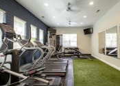 Thumbnail 9 of 26 - Fitness center with cardio equipment at Oasis at Cedar Branch in Wilmington, NC