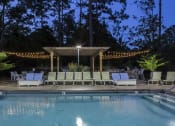 Thumbnail 9 of 31 - Pool at nighttime at Oasis at Twinwood in Wilmington, NC