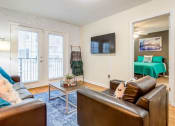 Thumbnail 21 of 31 - Living room with patio doors at Oasis at Twinwood in Wilmington, NC