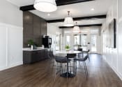 Thumbnail 11 of 27 - a dining room and kitchen with a table and chairs