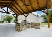 Thumbnail 4 of 26 - an outdoor kitchen with a grill and a fireplace