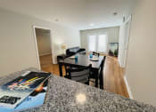 Thumbnail 14 of 26 - Kitchen bar overlooking dining space at Oasis at Cedar Branch in Wilmington, NC