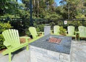 Thumbnail 10 of 31 - Fire pit with lounge chairs at Oasis at Twinwood in Wilmington, NC