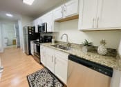 Thumbnail 18 of 31 - Kitchen with granite counters at Oasis at Twinwood in Wilmington, NC