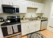 Thumbnail 15 of 31 - Stainless steel appliances in kitchen at Oasis at Twinwood in Wilmington, NC