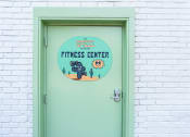 Thumbnail 30 of 34 - a green door with a sign that says the oasis fitness center