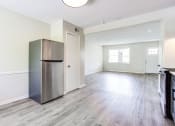 Thumbnail 13 of 34 - a kitchen and living room with hardwood floors and white walls  at The Oasis on Cascade, Atlanta, GA, 30310