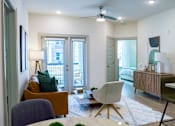 Thumbnail 5 of 36 - A living room with a white ceiling fan and a white rug on the floor.