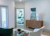 Thumbnail 6 of 36 - A living room with a white couch and a wooden cabinet.